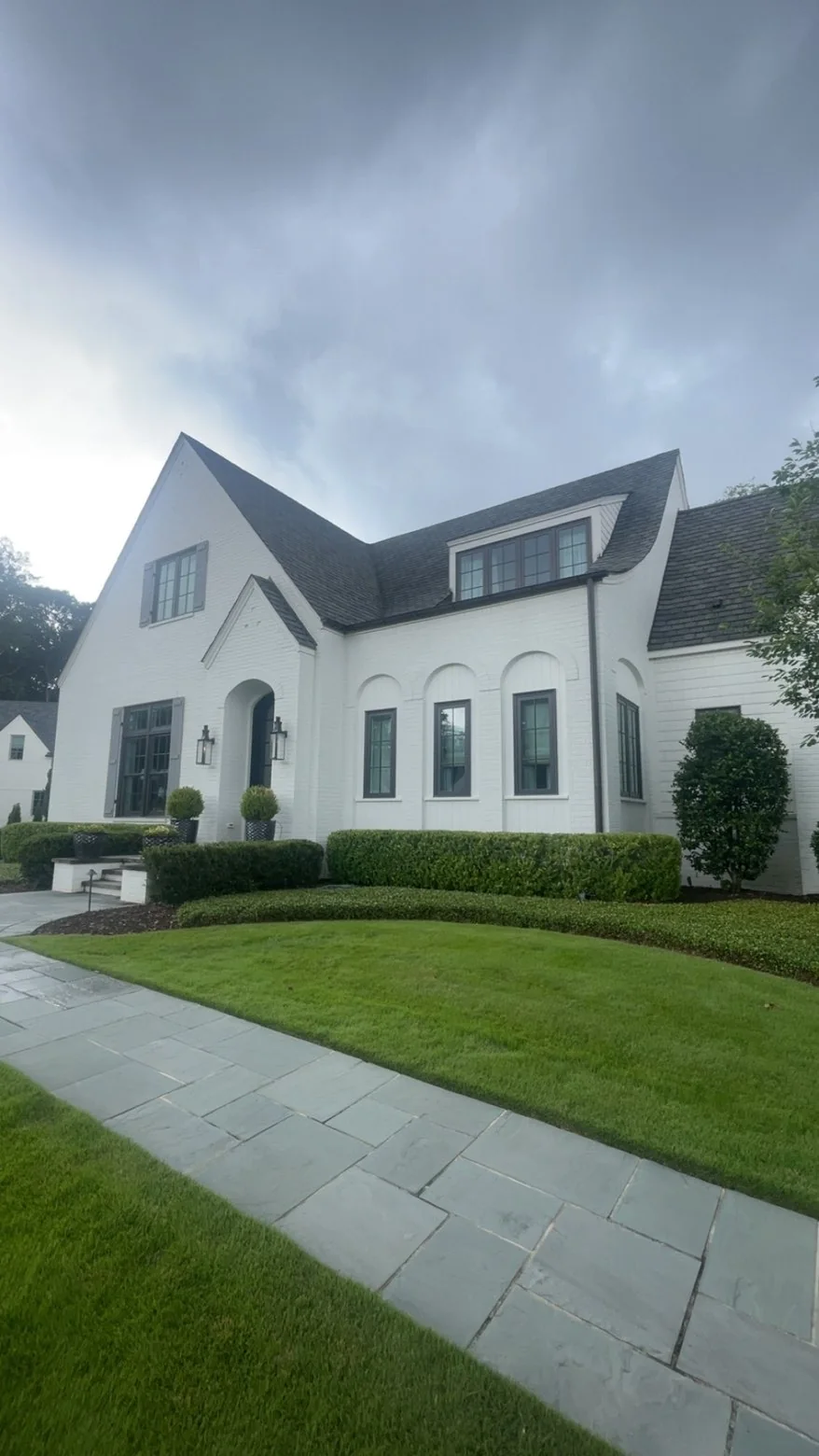 Modern white home with clean windows and landscaping